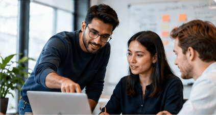 A small product team reviewing work around a laptop